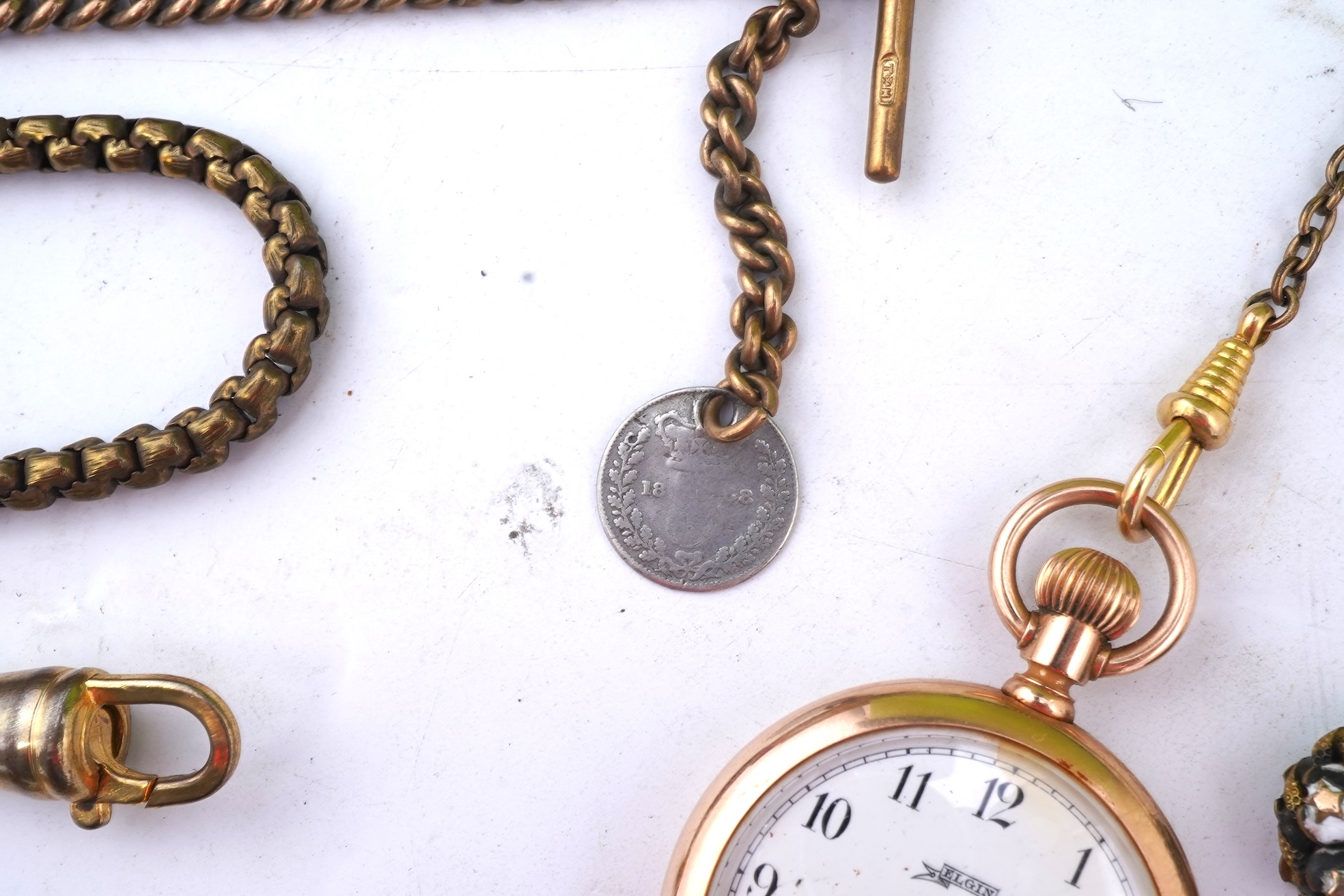 A group of gilt metal/pinchbeck jewels, 19th and early 20th century, comprising: a brooch of knotted design; two gate bracelets; a fancy link bracelet; an open-faced pocket watch; two oval panel brooches, and two watch c